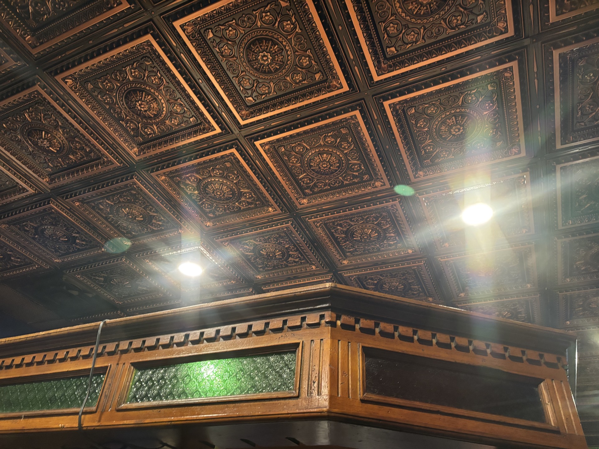 Ornate tin ceiling and stained glass details